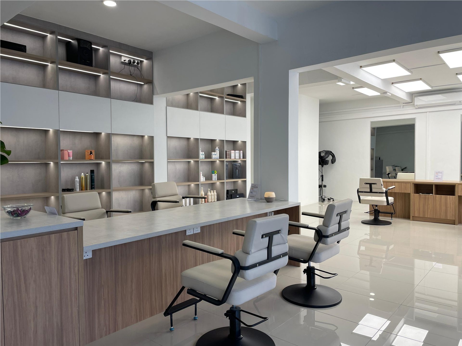 Bright GIP Kota Damansara interior with pale wood, stone counters and cream chairs
